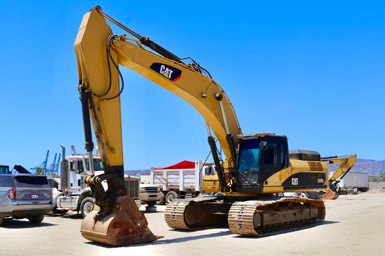 Excavadora Caterpillar 330DL frente a la zona portuaria.
